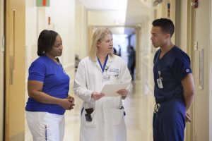 An MUSC clinician speaks to two employees about the day's plans. 