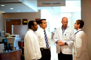 A group of staff member discuss work at Hollings Cancer Center. 
