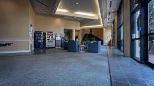 Inside the lobby of the Harper Student Center, showing tables and vending machines. 