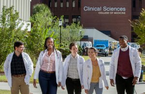 Students walk together after a day of learning at the College of Medicine and the Clinical Sciences building.