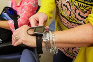A patient adjusts a writ monitor at the College of Health Professions. 